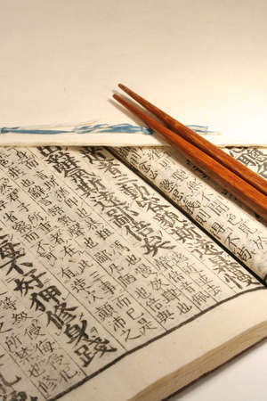 Old Japanese book from meiji period with chopsticks and japanese maple leafの写真素材