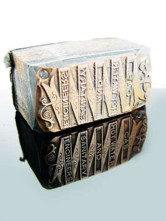 Old Letterpress Type, reflections in a shinny black ceramic tileの写真素材