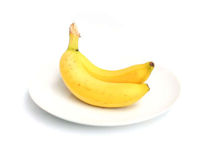 two bananas on a white plateの写真素材
