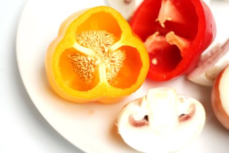 red and yellow bell peppers on plate with Mushroomの写真素材