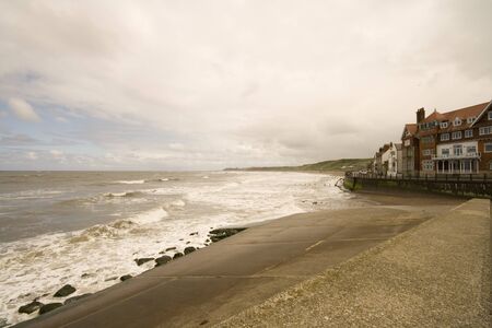 Stormy sea at Sandsend near Whitby in North Yorkshire, looking down the beach.の写真素材