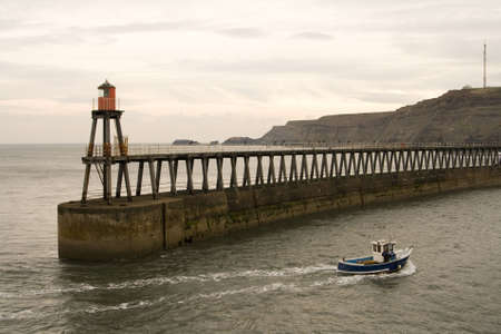 View of Whitby Harbour, overcast sky, With boat.の写真素材