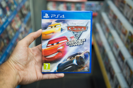 Bratislava, Slovakia, June 1, 2017: Man holding Cars 3 Driven to Win videogame on Sony Playstation 4...