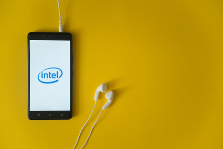 Los Angeles, USA, october 23, 2017: Intel logo on smartphone screen and earphones plugged in on...