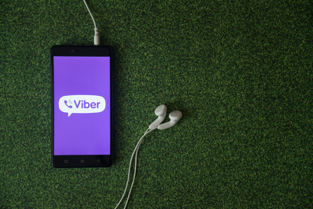 Foto de Los Angeles, USA, october 23, 2017: Viber logo on smartphone screen on green grass background. - Imagen libre de derechos