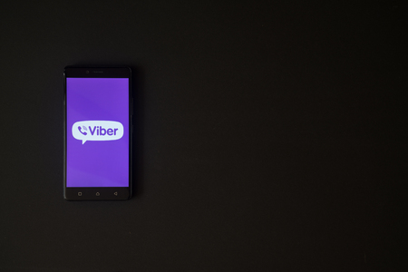 Foto de Los Angeles, USA, october 19, 2017: Viber logo on smartphone screen on black background. - Imagen libre de derechos