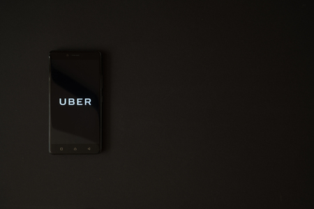 Los Angeles, USA, october 19, 2017: Uber logo on smartphone screen on black background.のeditorial素材