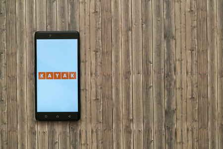 Los Angeles, USA, november 7, 2017: Kayak logo on smartphone screen on wooden background.