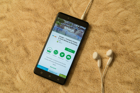 London, november 14, 2017: Trivago application in google play store on sandy background and...