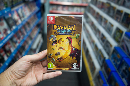 Bratislava, Slovakia, december 2, 2017: Man holding Rayman legends videogame on Nintendo Switch...