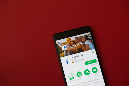 Los Angeles, december 11, 2017: Smartphone with Facebook lite application in google play store on red backgroundのeditorial素材