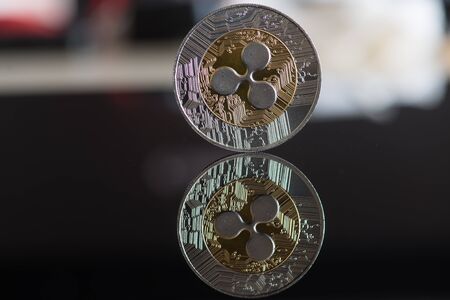 Ripple cryptocurrency coin on mirror backgroundの写真素材
