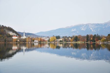 Lake Bledâs famous island with a church rests in the middle of the lake. A medieval castle perches on a cliff above Lake Bled & offers the best views of the lake itself and the surrounding Alpine peakの写真素材