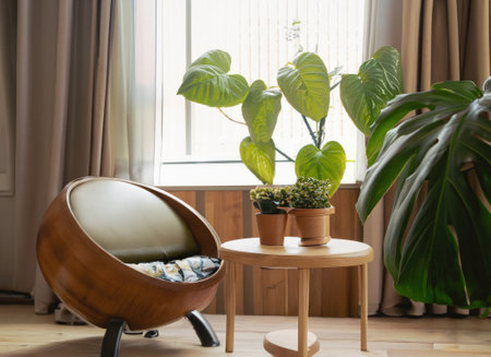 chair and round wooden coffee table against window near paneling wallの素材