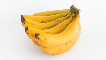 Organic, yellow and ripe bananas on white backgroundの写真素材