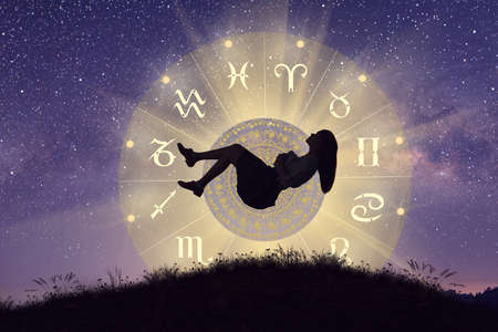 Astrological zodiac signs inside of horoscope circle. Woman lavitaing over the zodiac wheel with...