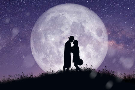 Silhouette at night landscape of couple or lover dancing and singing on the mountain with Milky way...