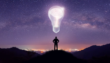 Silhouette of Businessman on hill thinking idea. Light bulb with brain inside and low poly wireframe outside over City and Milky Way background. Creative and innovation inspiration. Business Bright idea concept.の写真素材