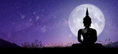 Silhouette of Buddha mediating with Full moon light at night.の写真素材