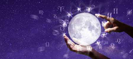 Astrological zodiac signs over the moon in hand. Knowledge of the stars in the sky. The power of the...