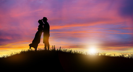 Silhouette at twilight landscape of couple or lover dancing and singing on the mountain with sunset background.の写真素材