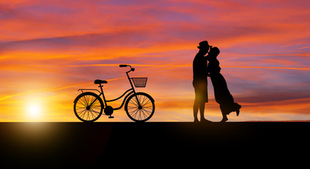 Silhouette at twilight landscape of couple or lover dancing and singing on the mountain with sunset background.の写真素材