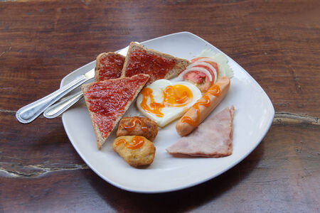 America breakfast and salads on wood table in morning