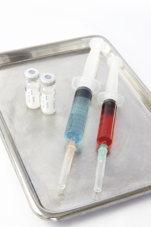 Vials and two syringe on stainless steel tray. On isolate.の写真素材