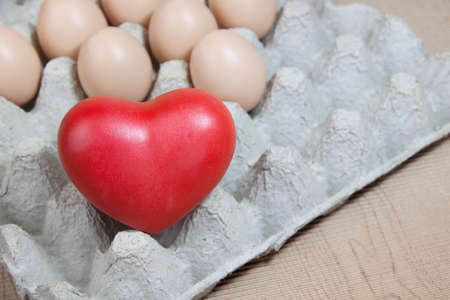 Heart and eggs on paper panelの写真素材
