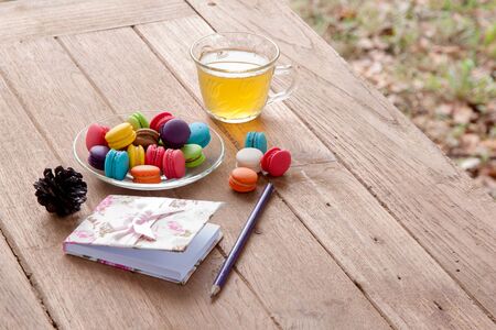 colorful french macaroon and tea on wood backgroundの写真素材