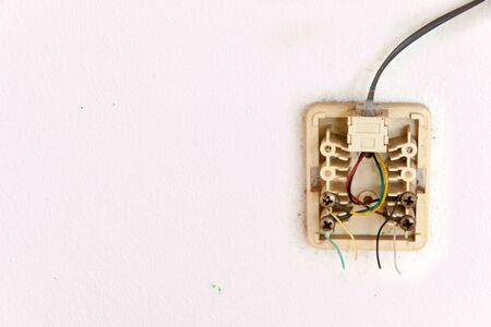 Phone lines are severed on white wall