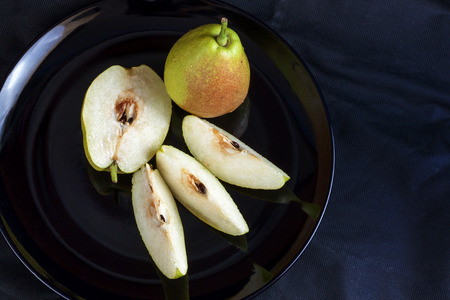 Fragrant pears . sweet fragrant flavor and aroma on black dishの写真素材