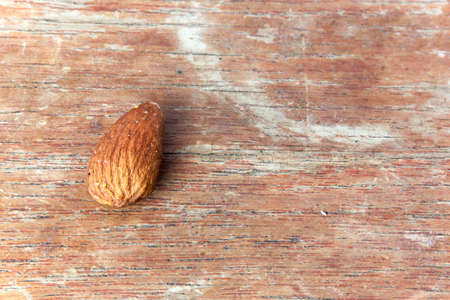 Almonds are roasted on wooden nature backgroundの写真素材