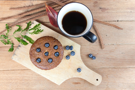 Banana muffin blueberries and hot coffee with for breakfast on wood table. Top view.の写真素材