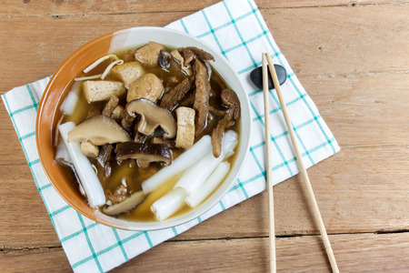 Vegetarian chinese roll noodle soup whit shiitake mushroom and tofu on wood table in Vegetarian festivalの写真素材