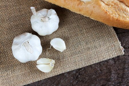 Garlic cloves on a vintage wooden background.の写真素材