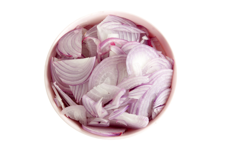 Sliced shallot onion in a pink bowl on white background object with work pathsの写真素材