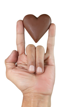 male hand showing Sign language means that I Love you and chocolate heart shape. Isolated on white with work paths.の写真素材