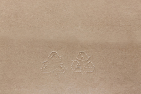 Stamp Recycling signs on recycling Natural color paper. Brown cardboard with horisontal stripsの写真素材