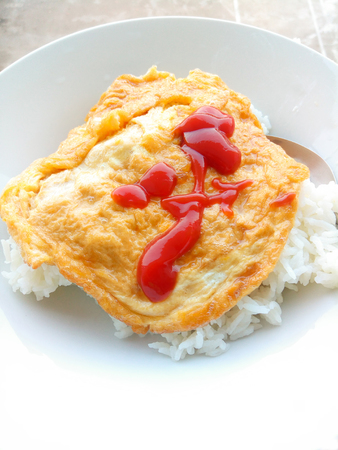 Omelet rice topped with ketchup in white plate. Thai Street Foodの写真素材