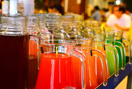 A Row Of Colorful  Juices Served in Jugの写真素材