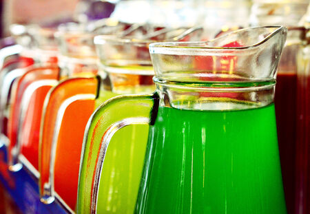 A Row Of Colorful  Juices Served in Jugの写真素材