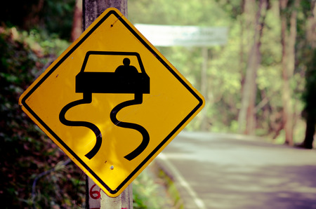 Caution of slippery roads - traffic signs beside country road