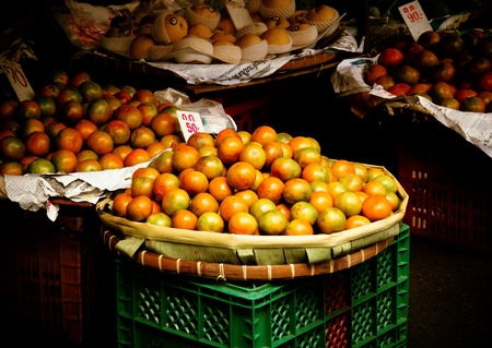 Orange fruits in basket for sale in urban market