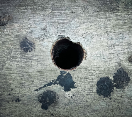 Black hole in cracked floor. Close up (hole, symbol, floor)の写真素材