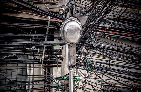 Lamp post on tangle of electrical Wires background  Bangkok Thailand