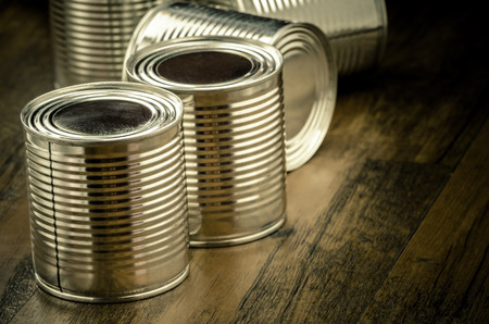 Tin cans for food on wooden background, Selective focusの写真素材
