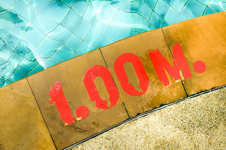 Swimming pool with Number 1.00 on ground at hotelの写真素材