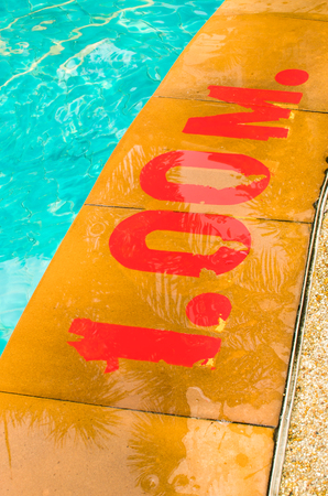Swimming pool with Number 1.00 on ground at hotelの写真素材
