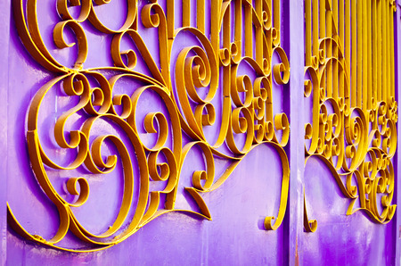 Beautiful yellow iron frame on purple rust Door, Used for texture or backgroundの写真素材